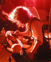 Look, Ma, I'm a rock stah! Darcy tunes before a show. Photo by Glenn Tucker